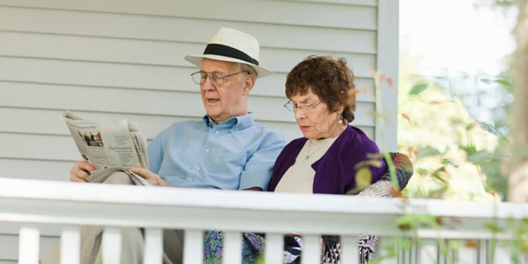 Elderly Couple Sitting Peacefully on Porch in Assisted Living