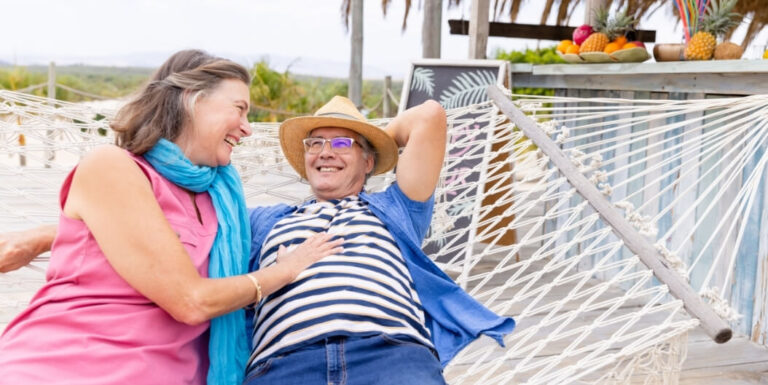 Elderly Couple Relaxing Together in a Hammock at an Independent Living Facility