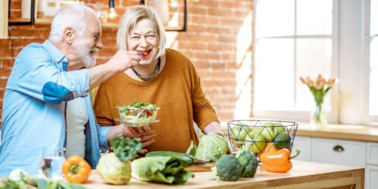 Elderly Couple Preparing Healthy Salad at Independent Living Facility