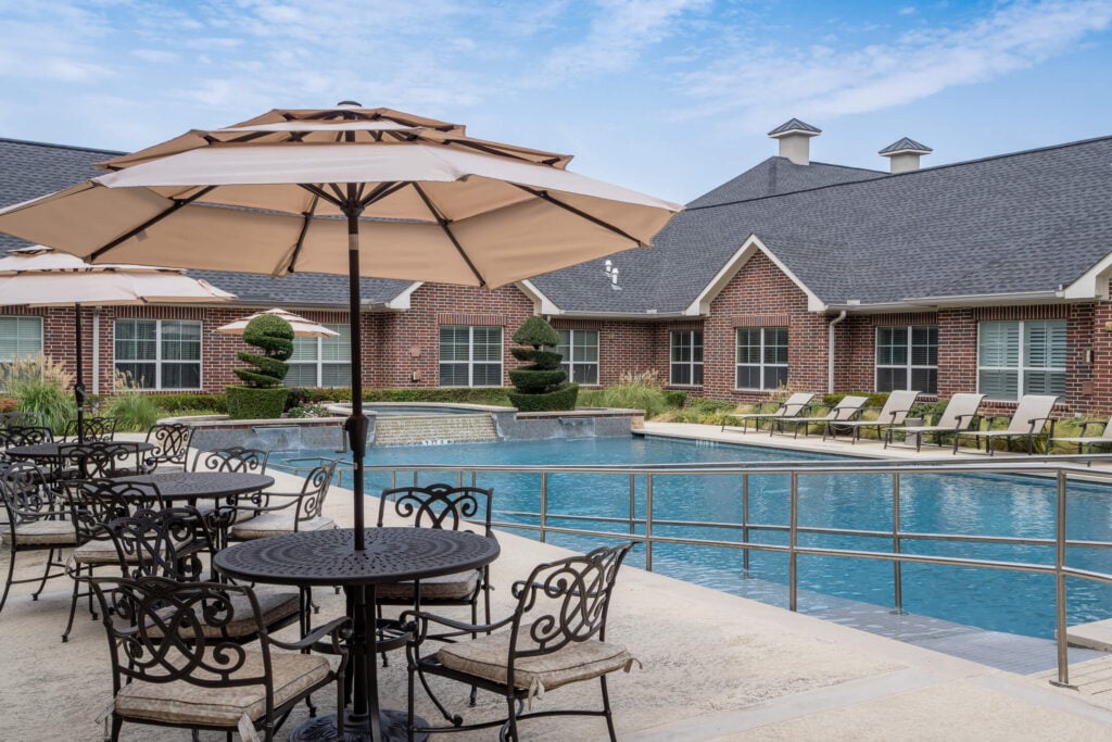 Poolside Seating With Umbrellas at Independent Living Facility